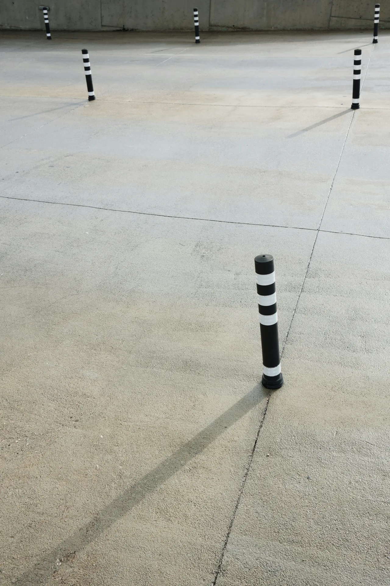 broom-finished concrete parking lot with bollards in Pittsburgh