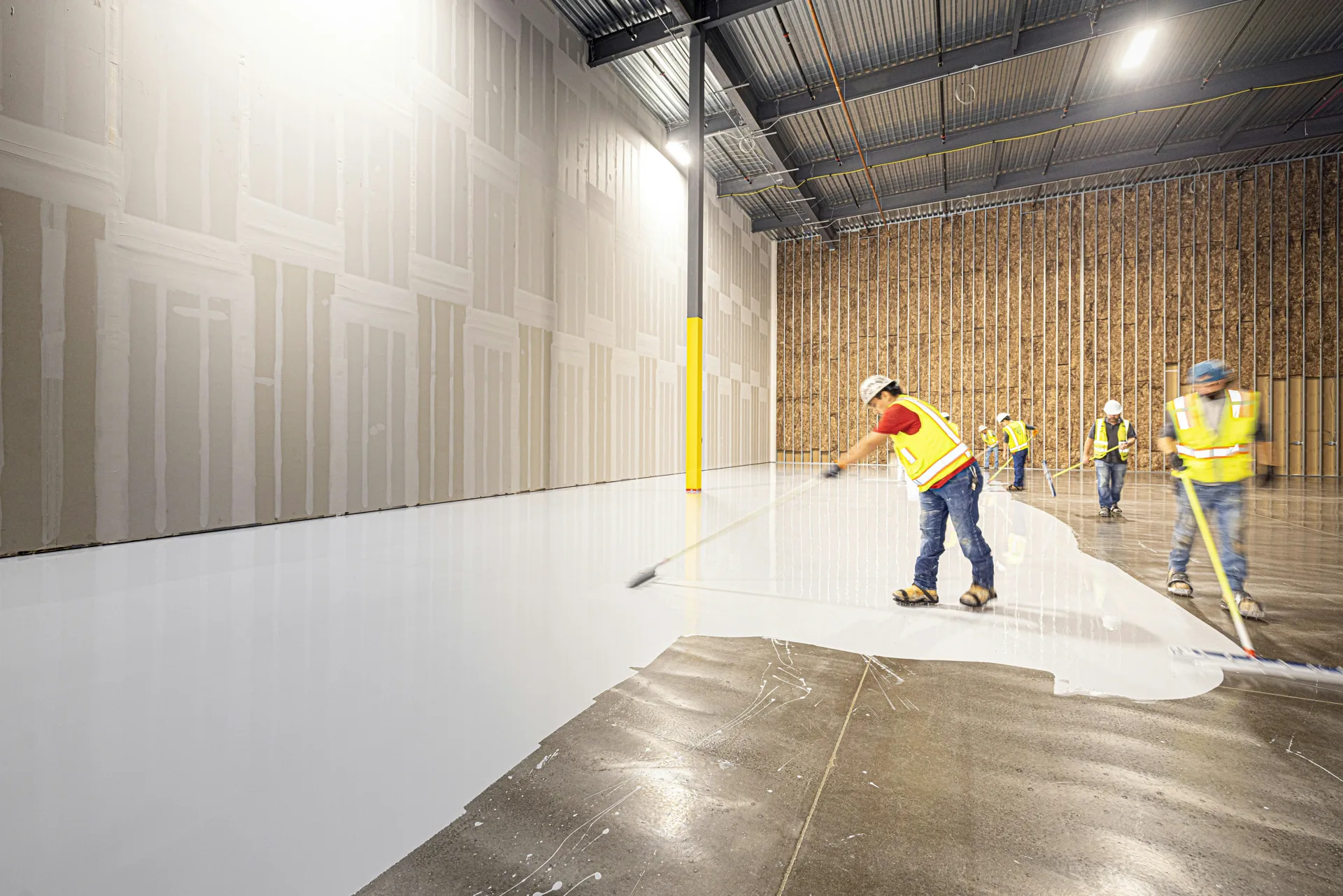 Rust-Oleum coating crew squeegeeing a base coat in Pittsburgh