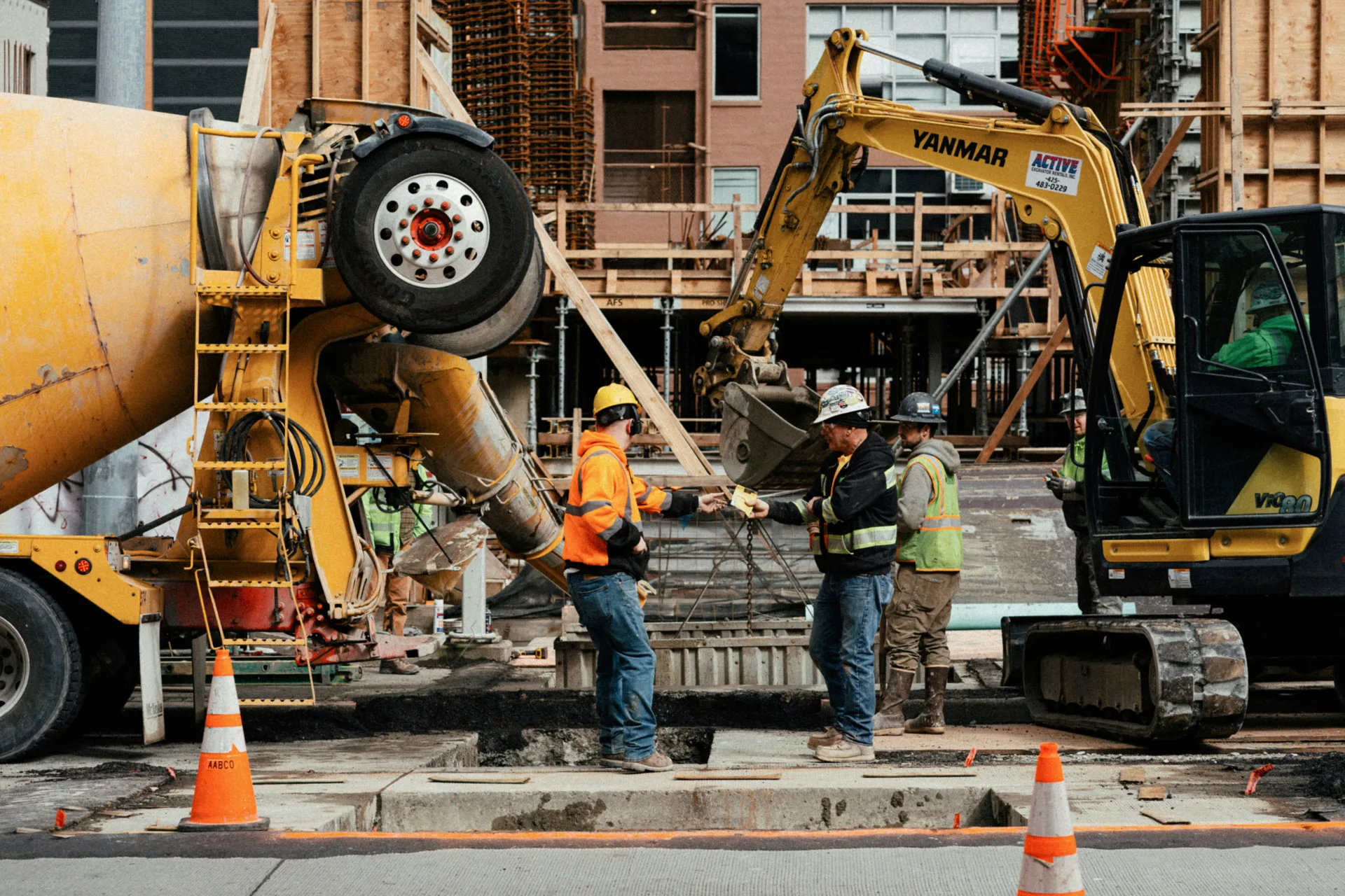 ready mix concrete pour on a Pittsburgh urban site with a mini excavator