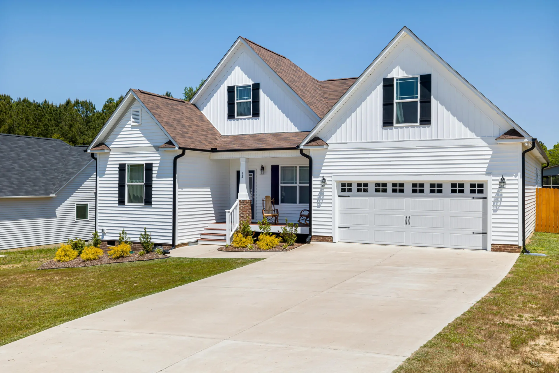 long concrete driveway at a Aliquippa acreage home with double garage