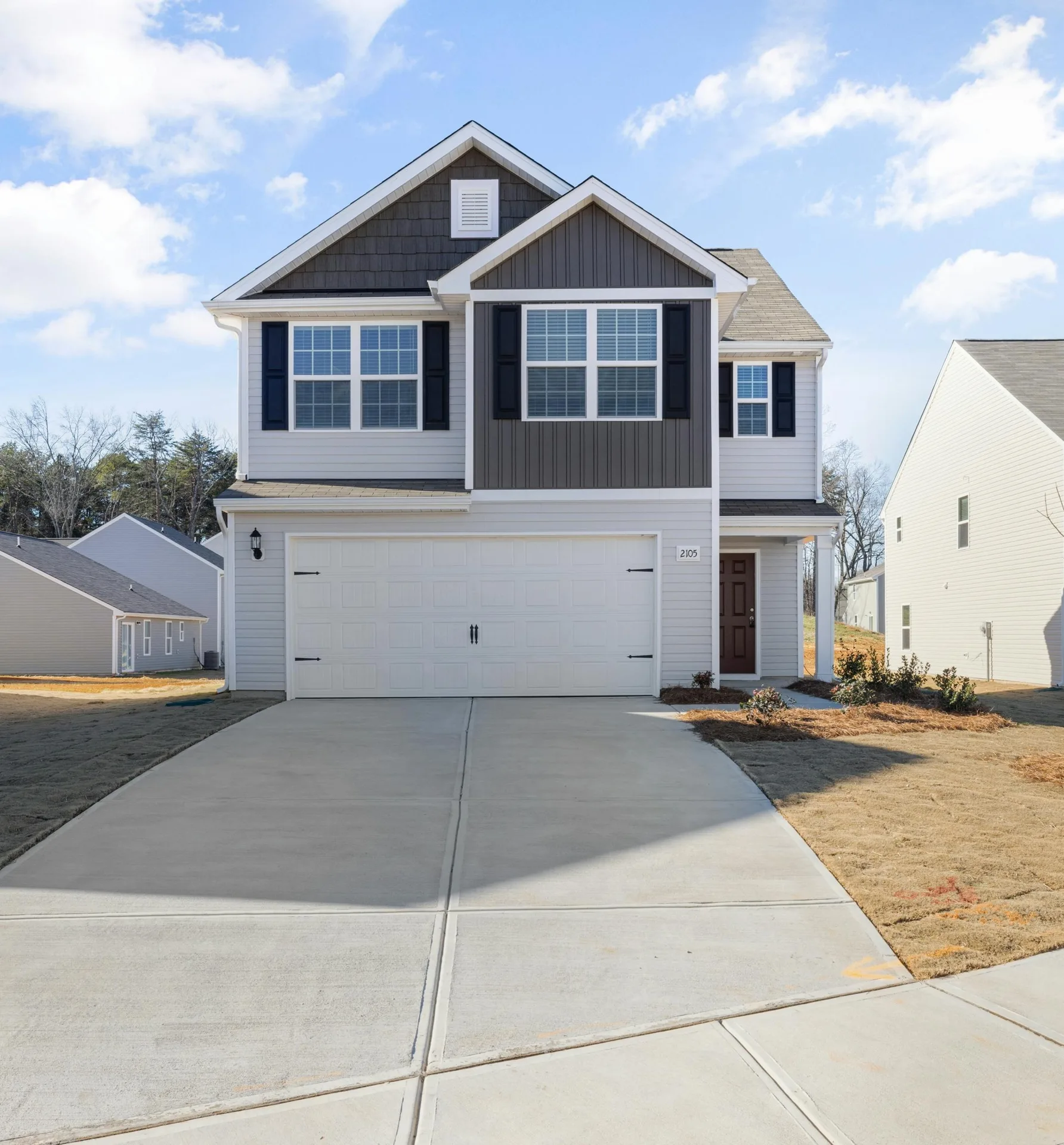 new concrete driveway at a grey new-build Pittsburgh home
