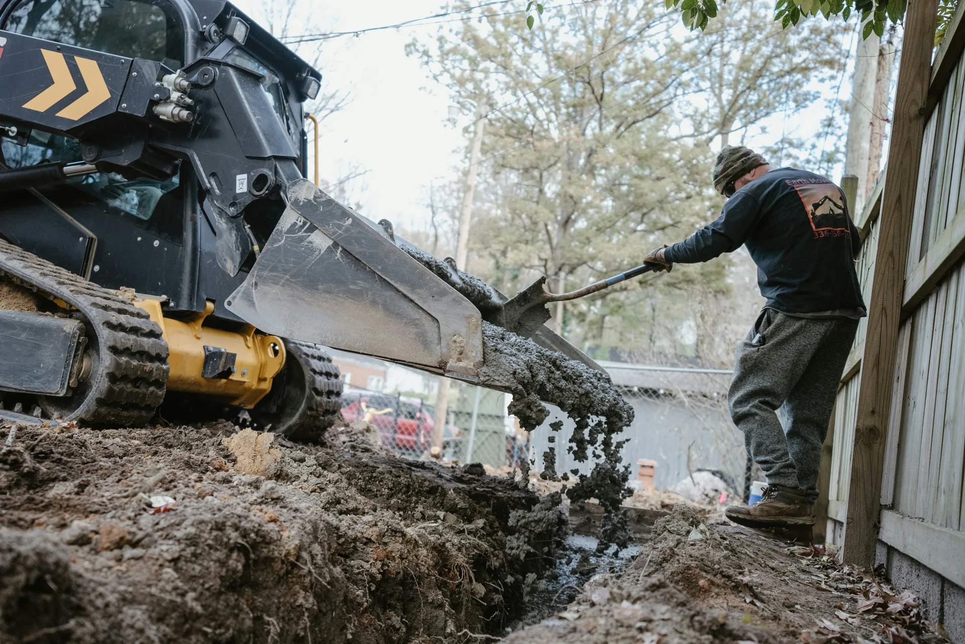 concrete foundation footing pour with a skid steer at a Pittsburgh site