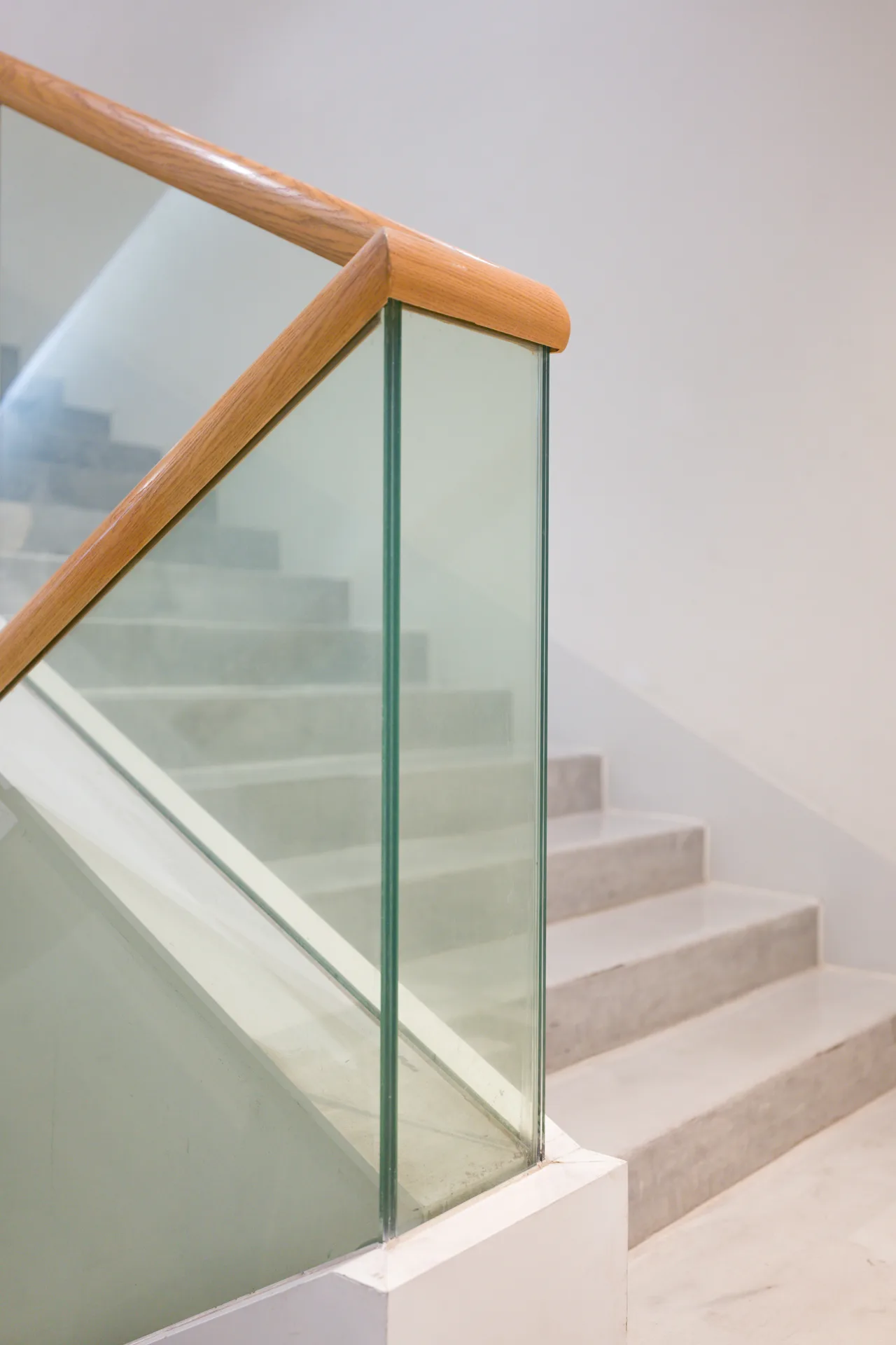 poured concrete staircase with glass railing at a Pittsburgh home
